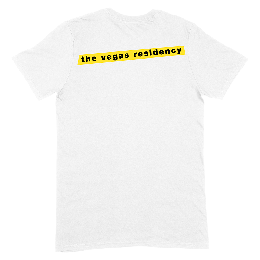 White t-shirt with yellow text reading ’the vegas residency’ on the front.