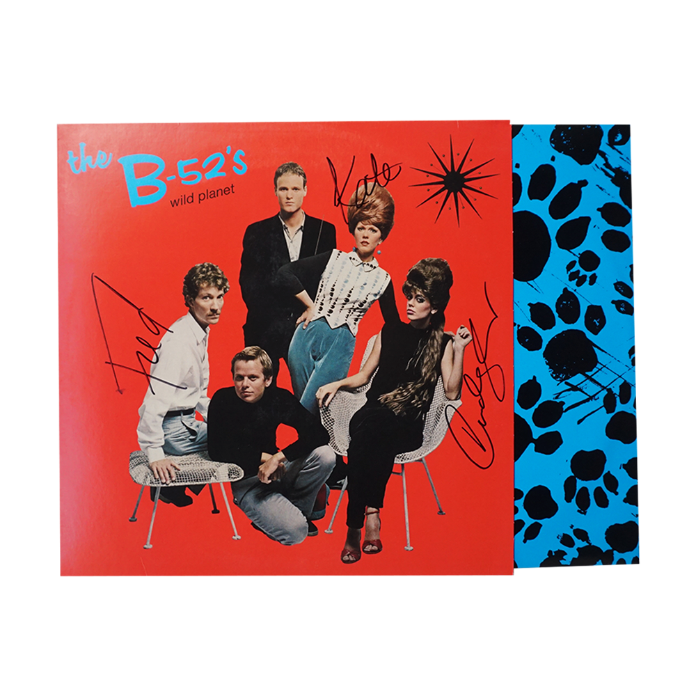 Wild planet vinyl signed album by the b-52s with vibrant red cover and blue paw-print patterned inner sleeve