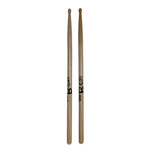 A pair of natural wood logo drumsticks with black b-52s branding from B-52s official merch