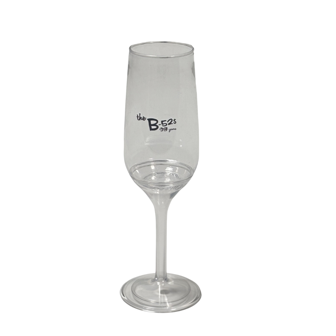 Clear glass champagne glass with the b-52s 70 years printed on the stem from b-52s official store