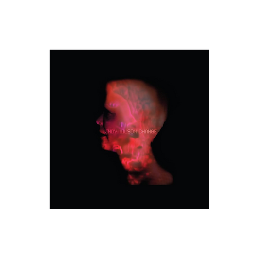 A glowing red and purple translucent skull silhouette on black background on the cindy wilson change cd cover by b-52s
